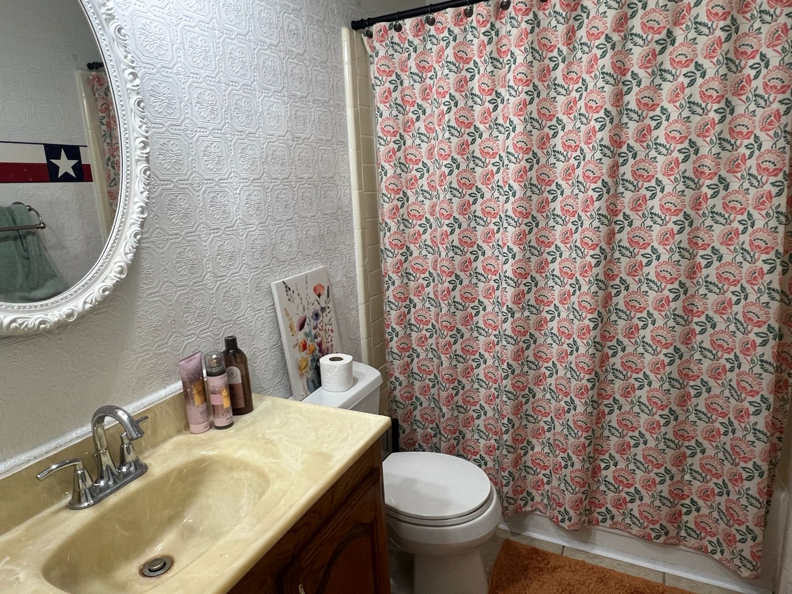 Clean bathroom with floral shower curtain