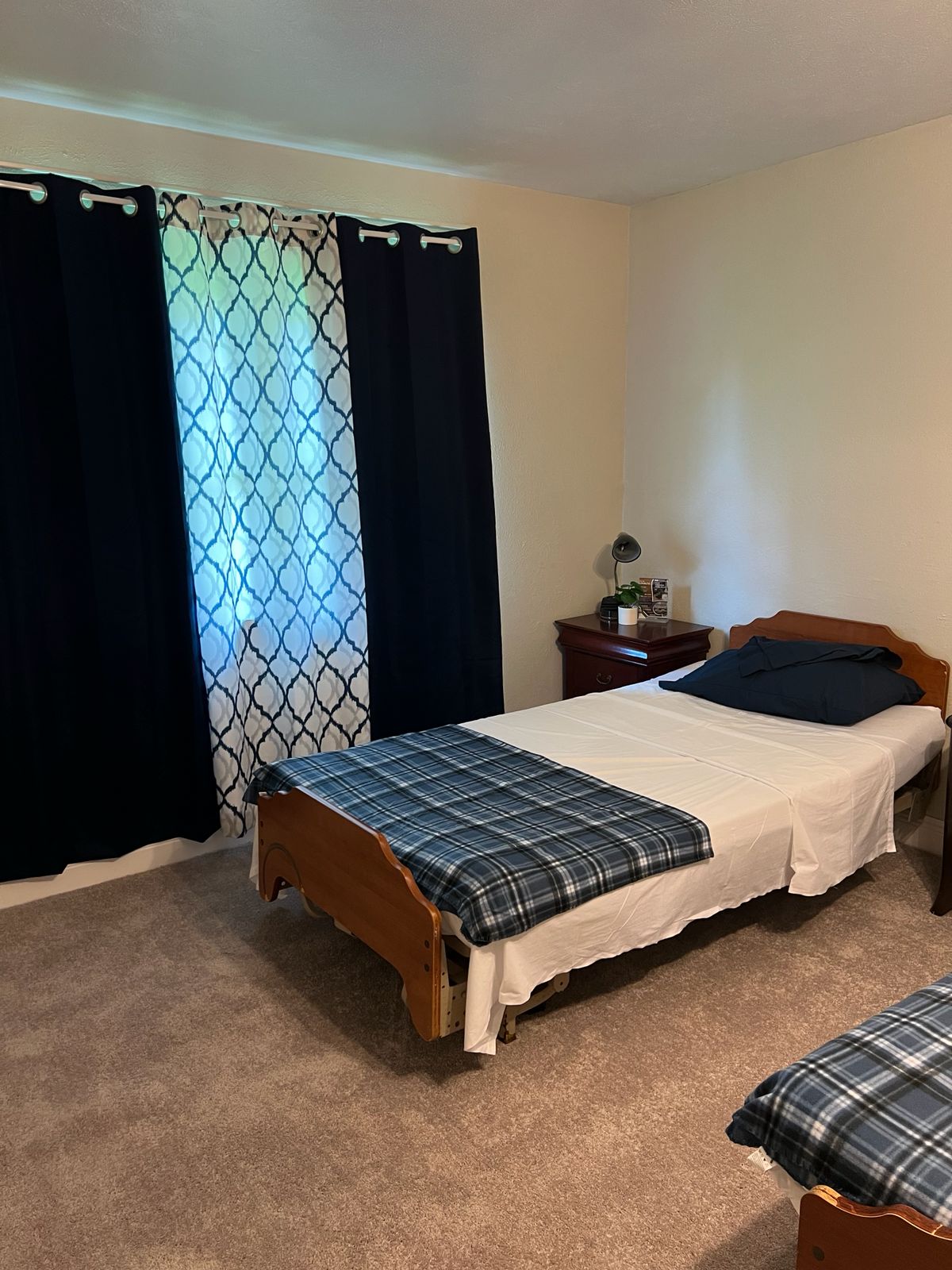 Cozy bedroom with plaid bedding and patterned curtains