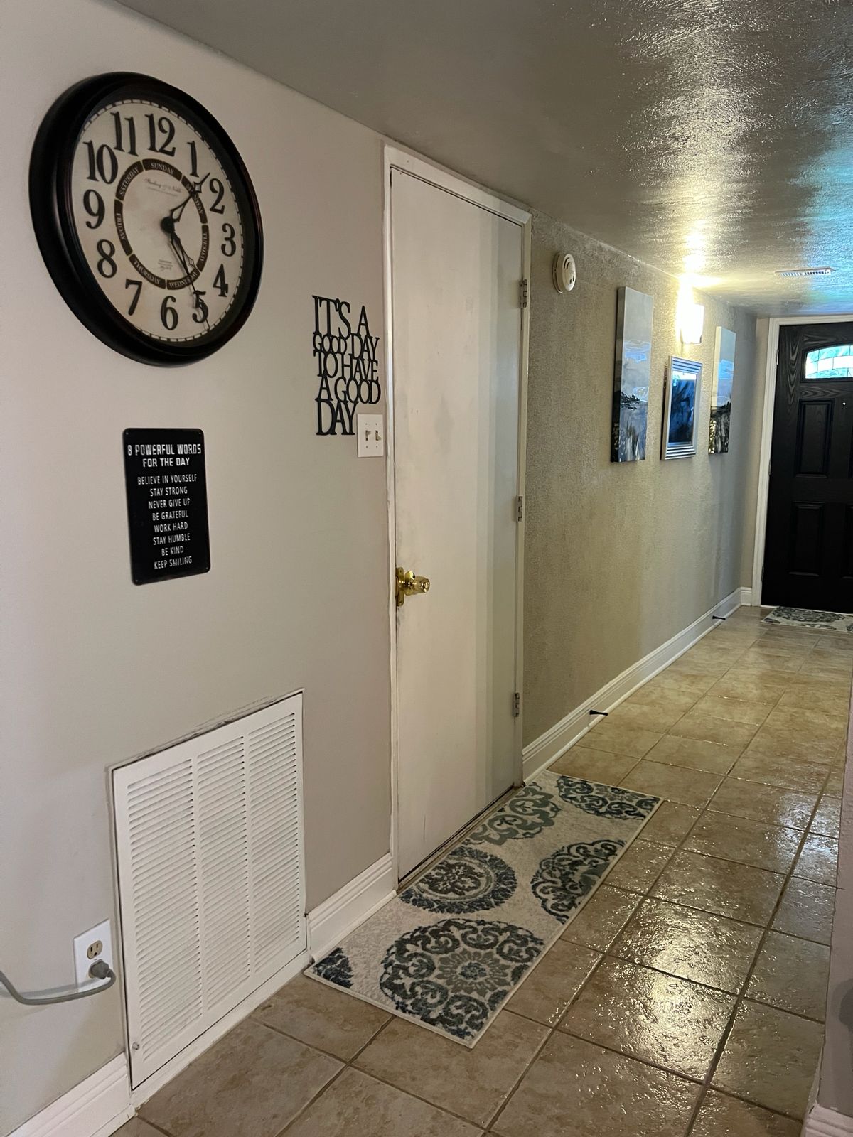 Welcoming hallway with wall clock and inspirational decor