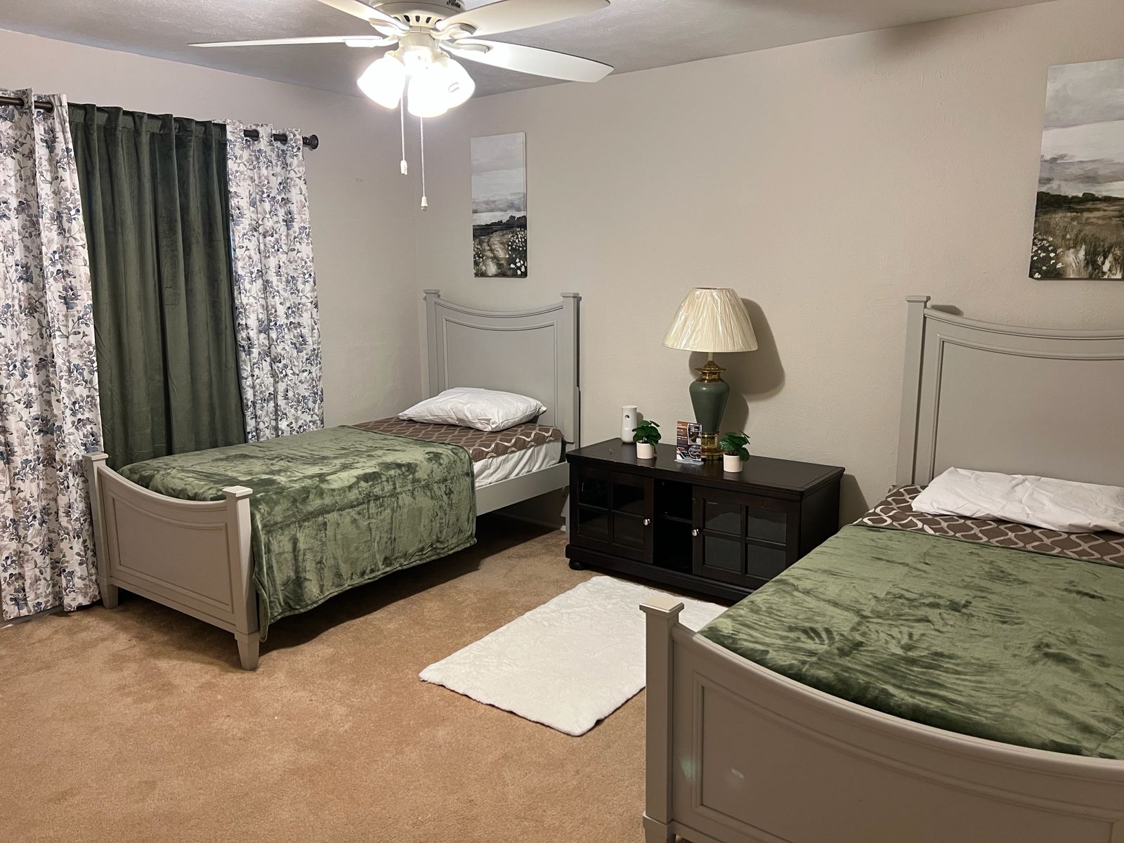 Shared bedroom with twin beds and soft green bedding