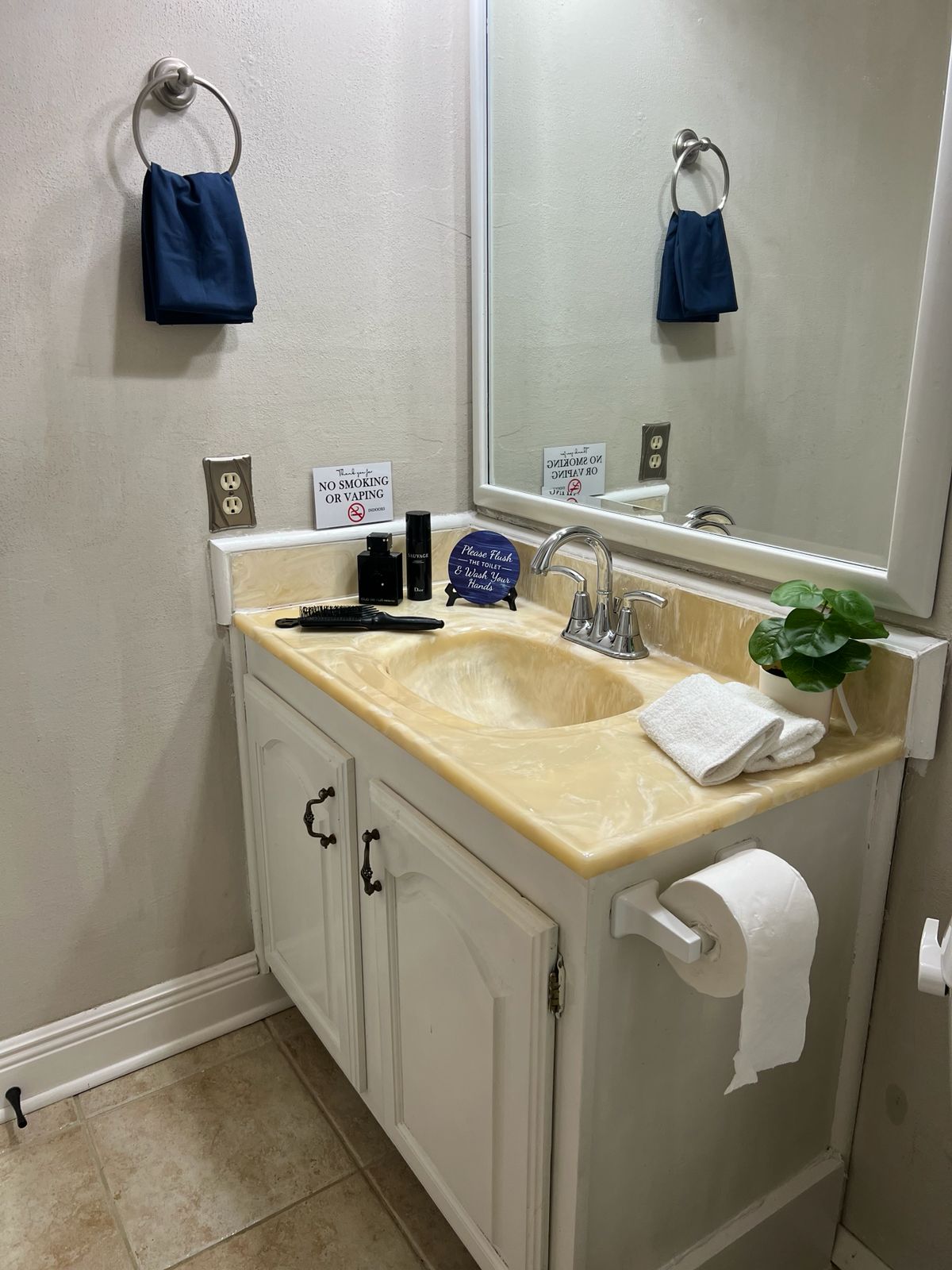 Bright bathroom with sink, mirror and fresh towels